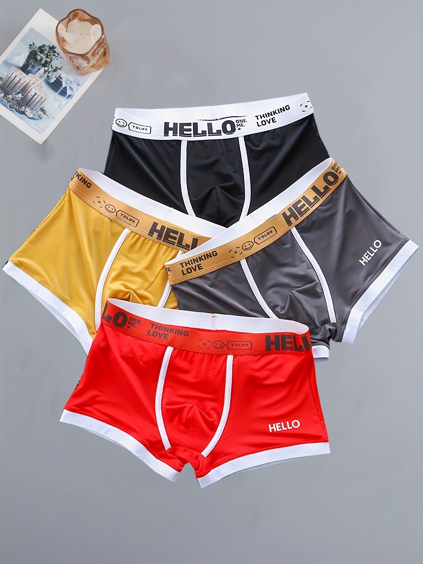 4 men's boxer briefs made with soft, breathable polyamide and elastane fabric featuring an alphabet pattern.