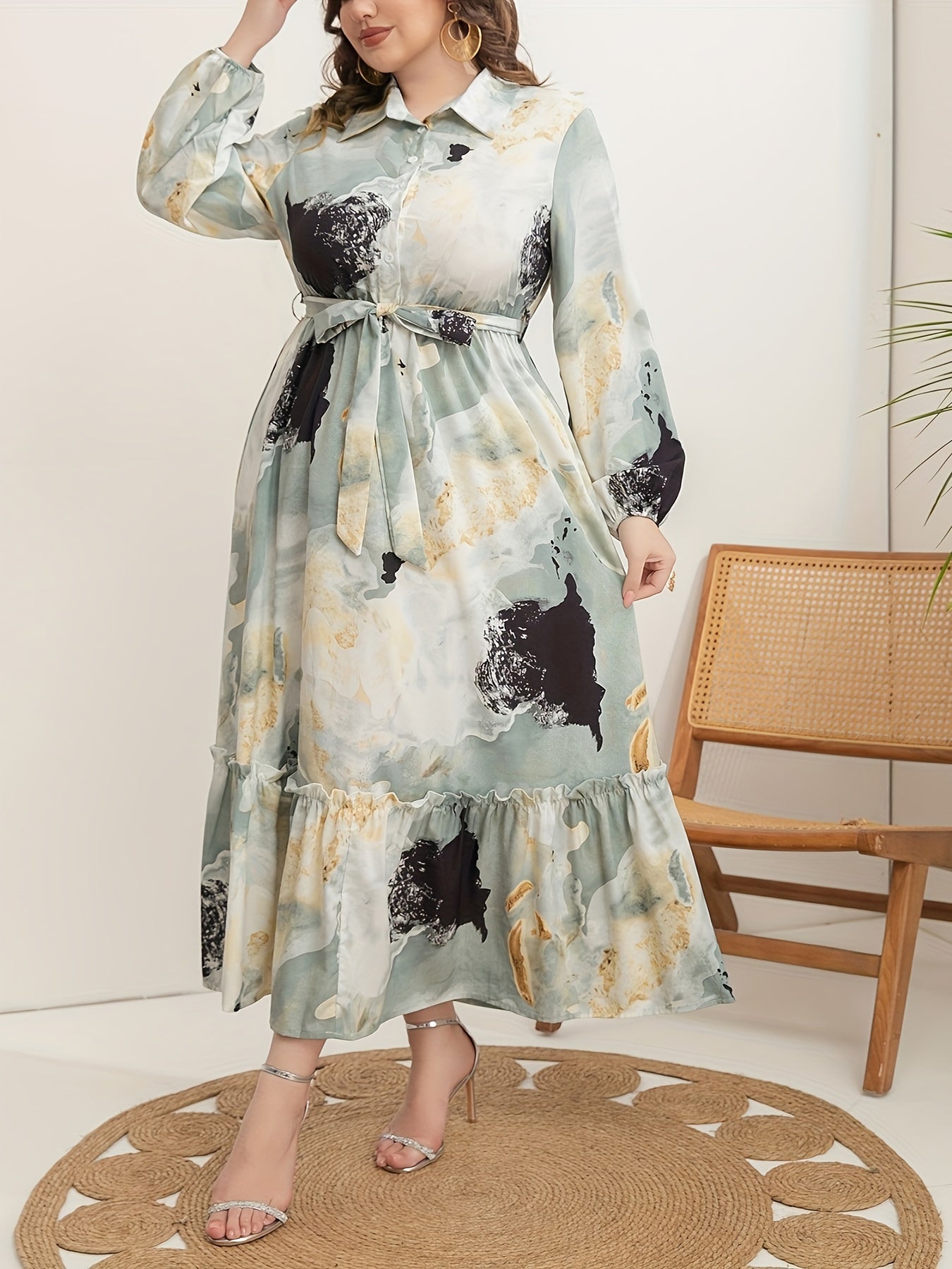 Stylish plus-size marble print dress for women features long sleeves, collar, ruffle hem, and belt. Versatile all-season fashion.