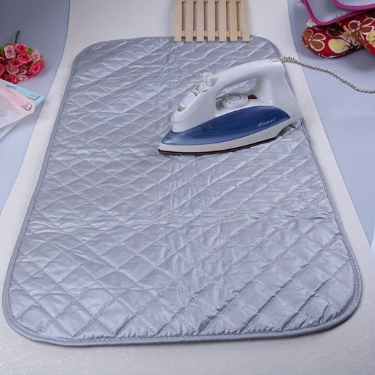 Portable and foldable ironing board made of thick cotton with a silvery coating, suitable for use at home, travel, hotel, dormitory, and as a desktop ironing pad.