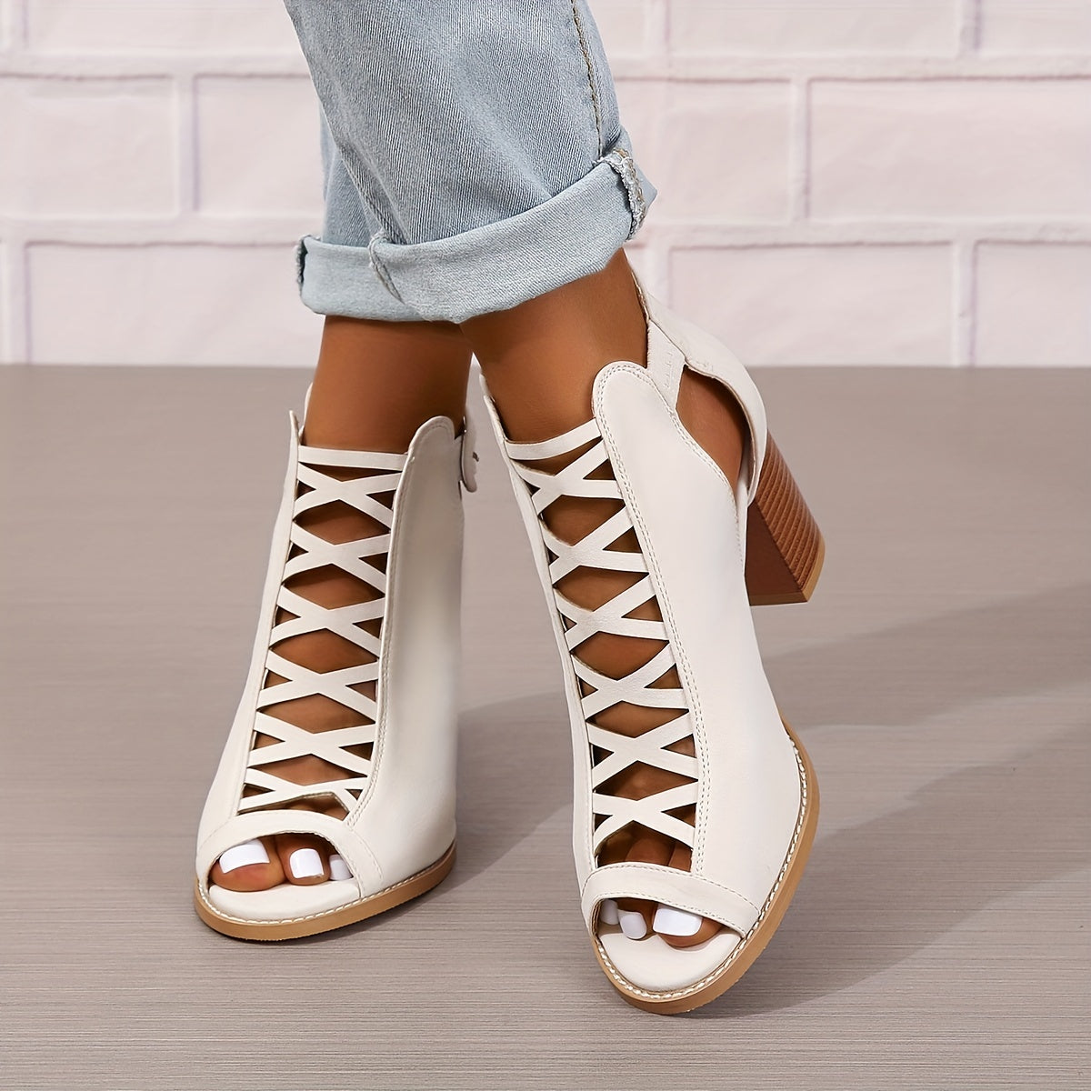 Women's brown faux leather ankle boots with elegant design including peep toe, chunky heel, crisscross straps, and buckle closure. Comfortable summer pumps with rubber sole.