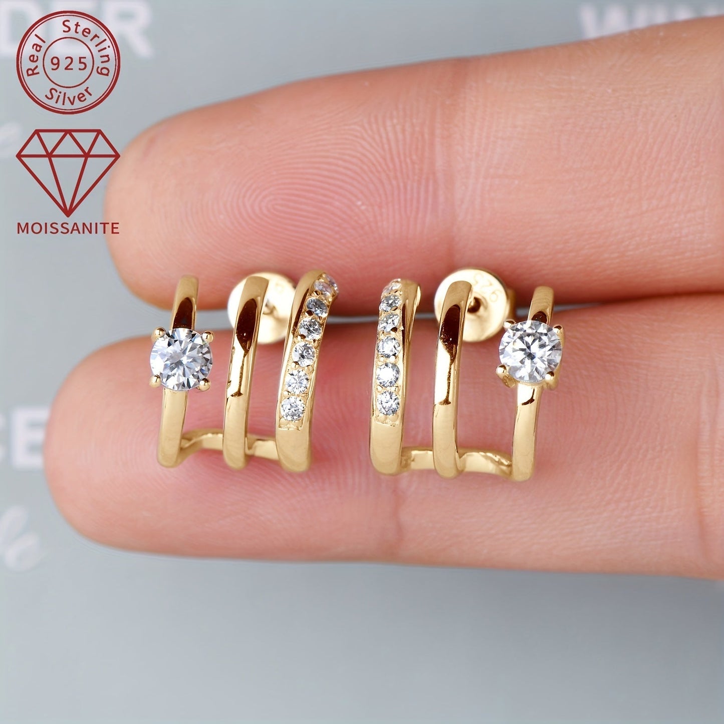 These stunning Moissanite earrings feature a total weight of 4.09g and are set with 4mm*2pcs, 1.6mm*14pcs, and 0.42ct*2pcs Moissanite stones. Crafted from 925 Sterling Silver, these Women's Fashion Half-Open Three-Ring Earrings are designed as a pair and