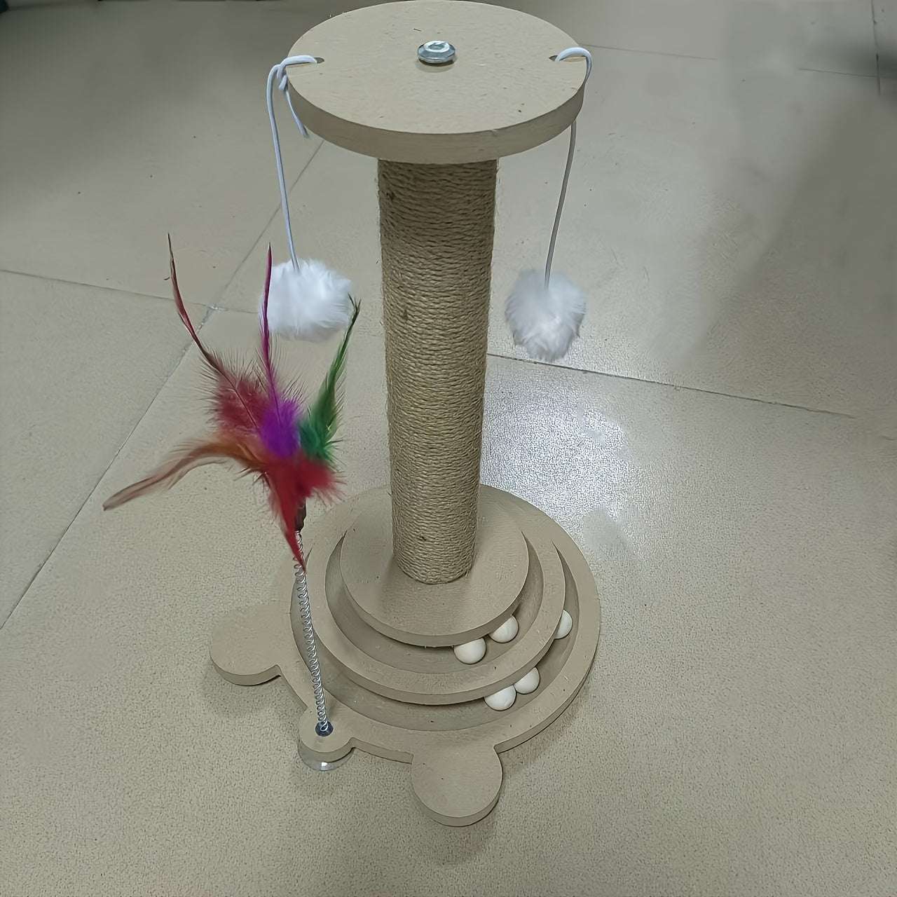 Sisal scratching post with rotating base and play balls for cats' claw care.