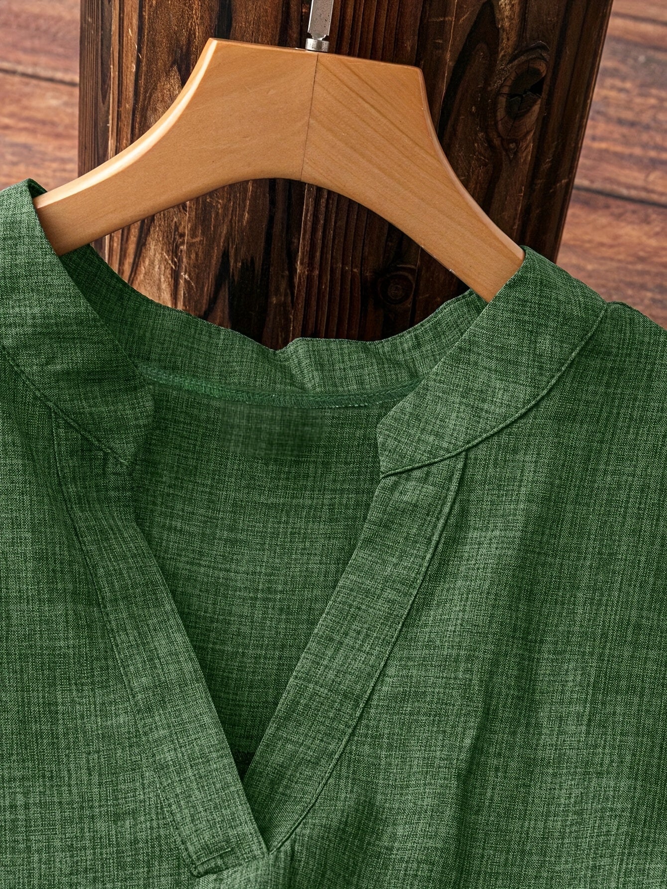 Casual polyester shirt with V-neck, half sleeves, asymmetrical hem, and faux button details for a weekend casual look in the spring/summer season.