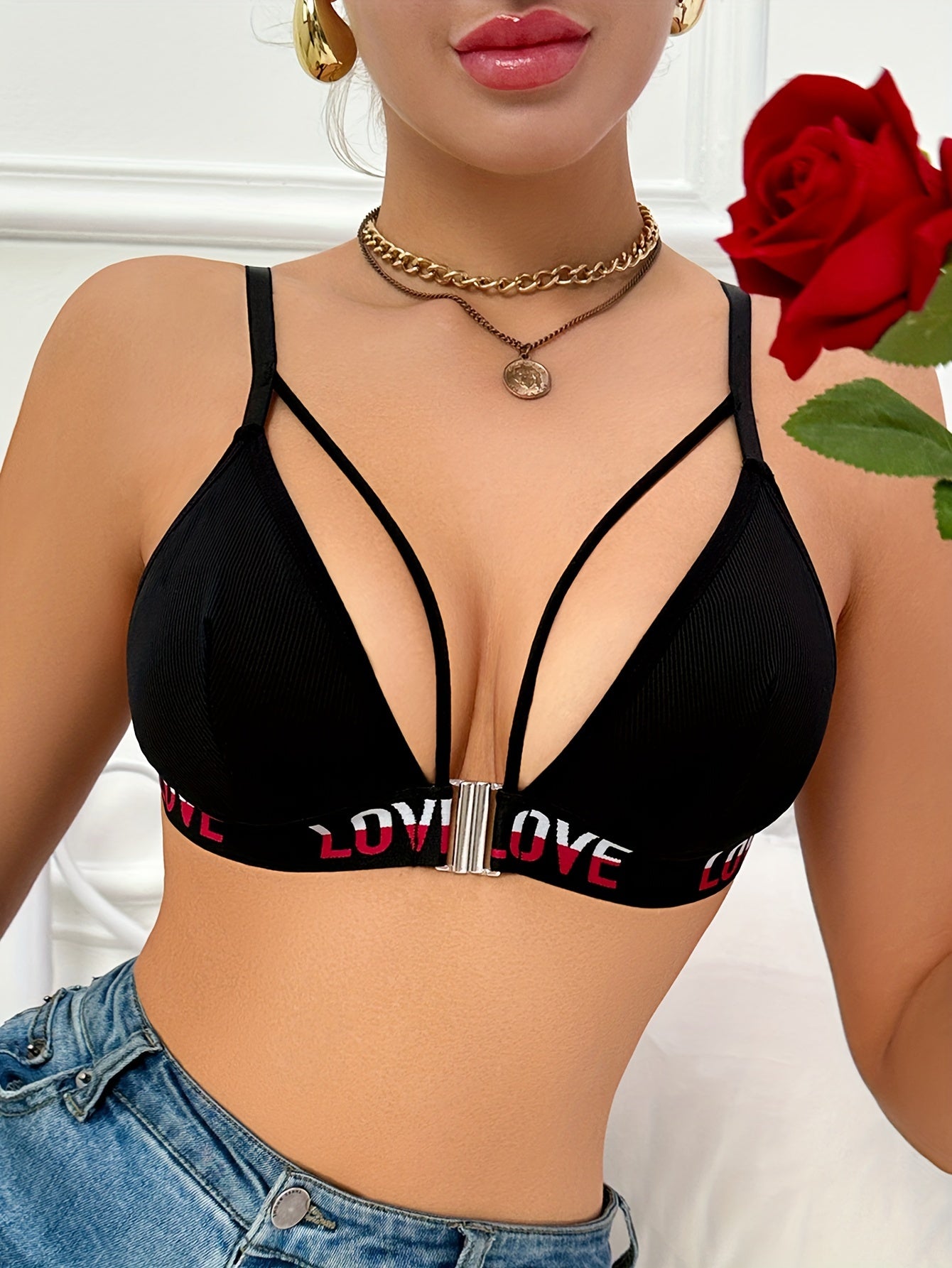 Women's black push-up bra with front closure, high support, and letter detailing. Made of soft polyester and elastane, hand wash only.