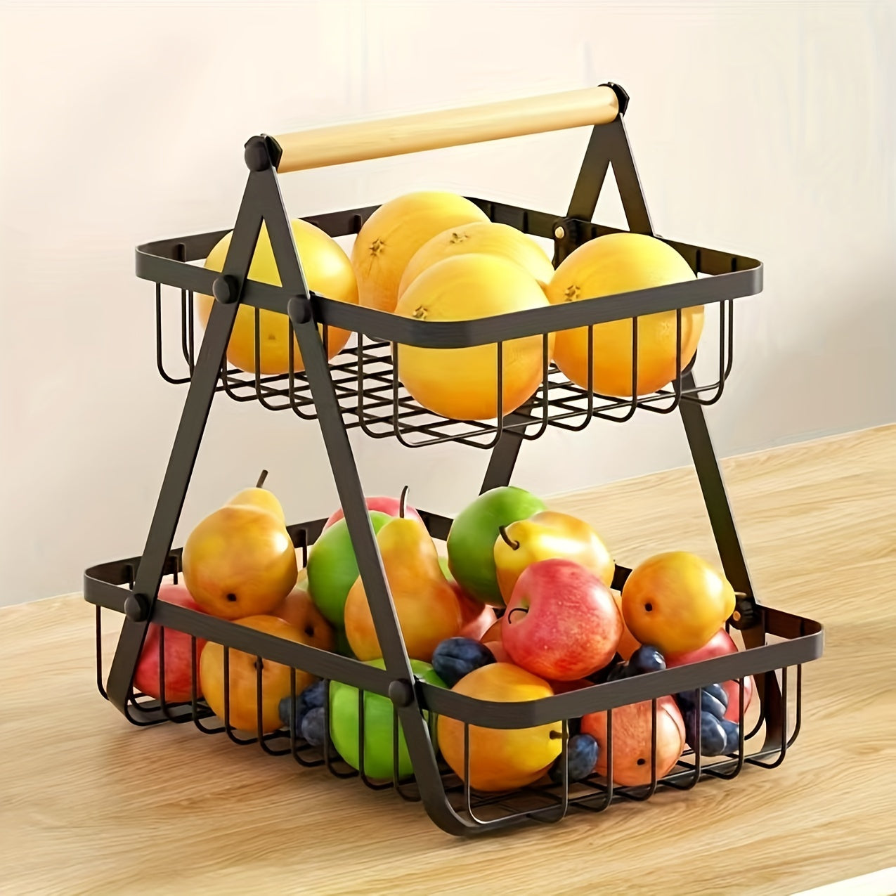 A contemporary metal fruit and vegetable basket featuring a detachable bowl-shaped storage compartment and a wooden handle for kitchen organization. Ideal for gifting during Christmas or Halloween, this handy organizer can be used on the countertop or in