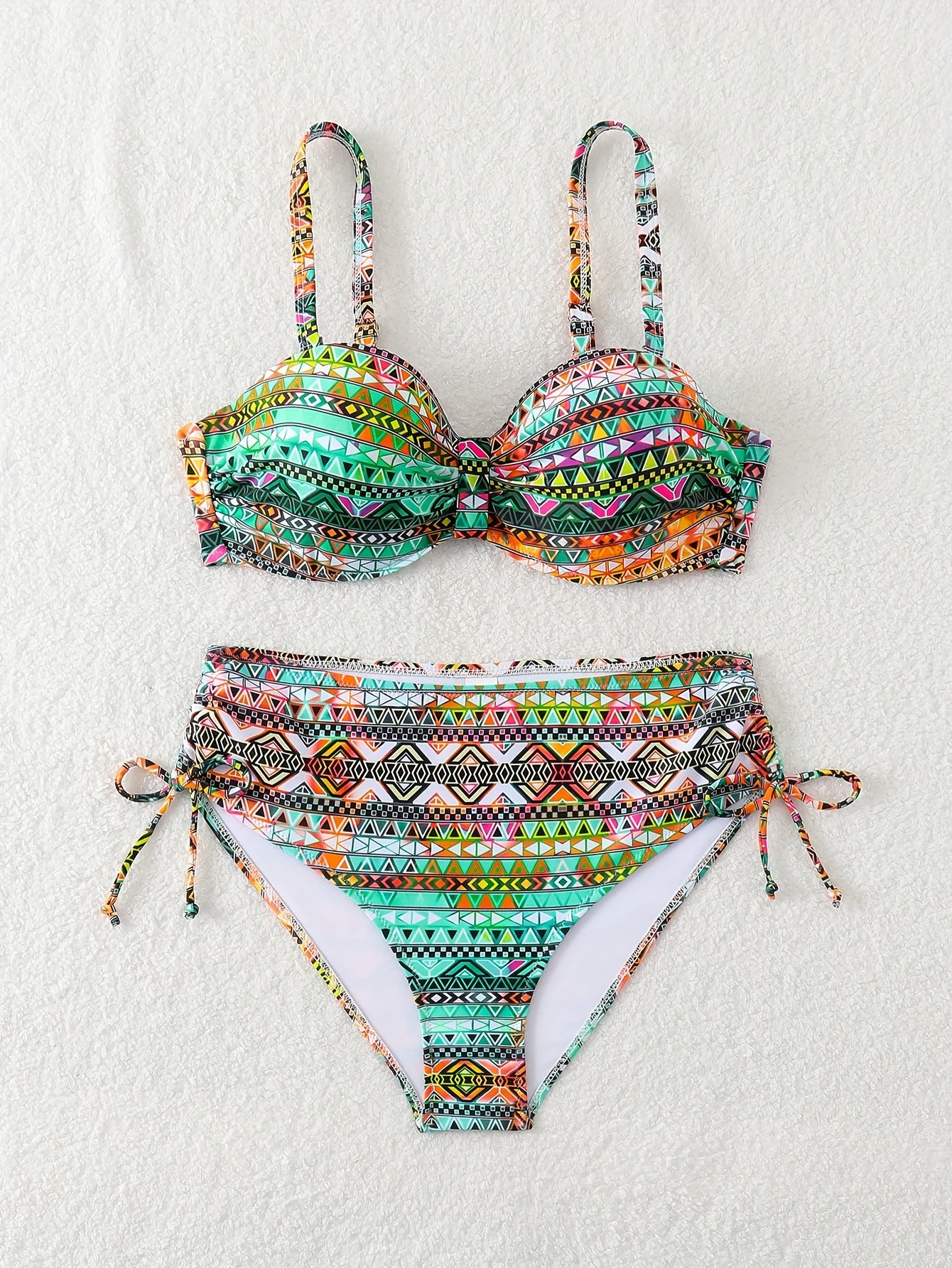 Two-piece set featuring vibrant printed pants with drawstring design and matching swimsuit.