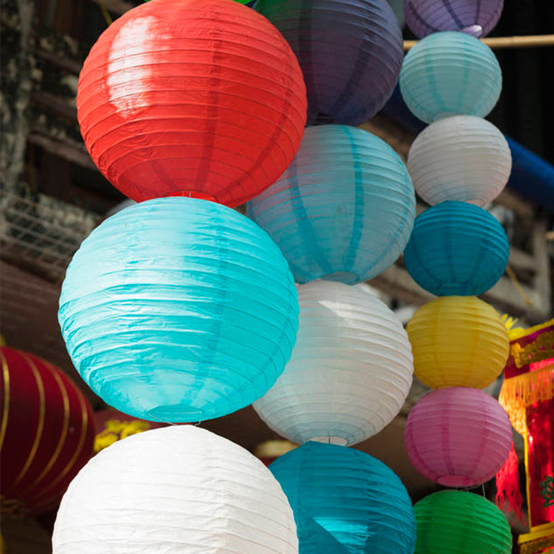 10 festive 7.9 inch paper lanterns in random colors for holidays and celebrations.