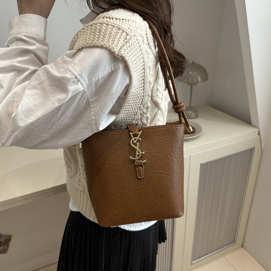 Elegant women's crossbody bucket bag with vintage style, adjustable strap, zipper closure, polyester lined. Available in black, white, dark brown, light brown. Suitable for work, commute