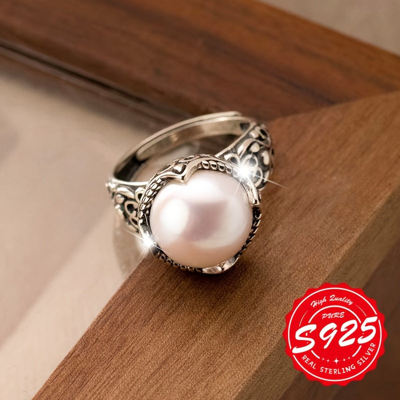 A stunning S925 sterling silver ring with a hollow carved imitation pearl, adorned with an antique Thai silvery design. This unisex Gothic style ring has an adjustable opening, making it perfect for any occasion. Lightweight at 4.16g, it is a great gift