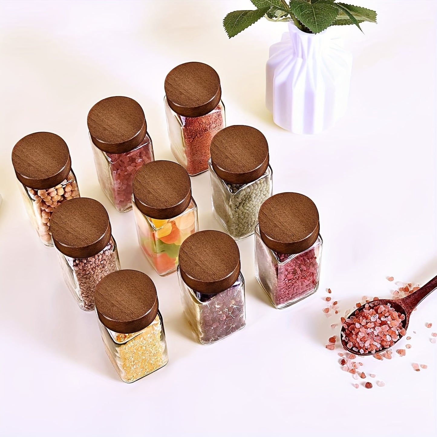 Set of 6, 12, or 24 glass spice jars with sandalwood lids. Each jar holds 120ml and comes with labels for kitchen organization.