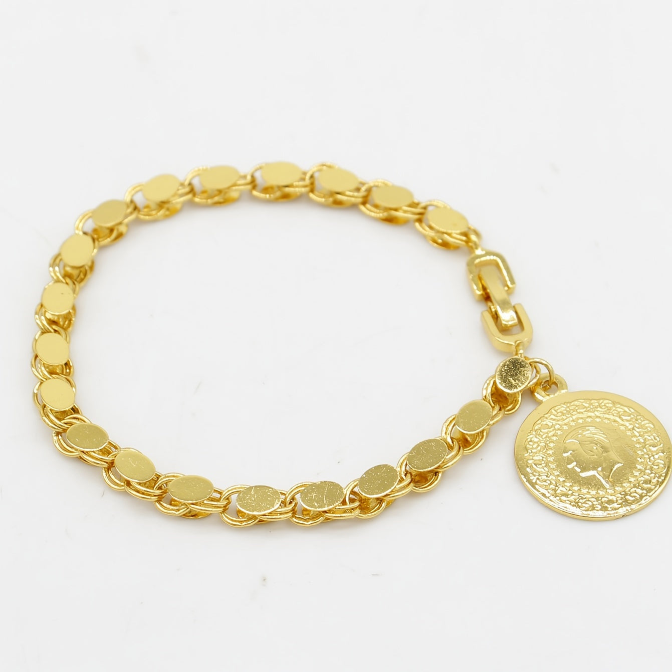 A handmade bracelet adorned with a gold-plated Turkish lira pendant, perfect for everyday or special occasions.