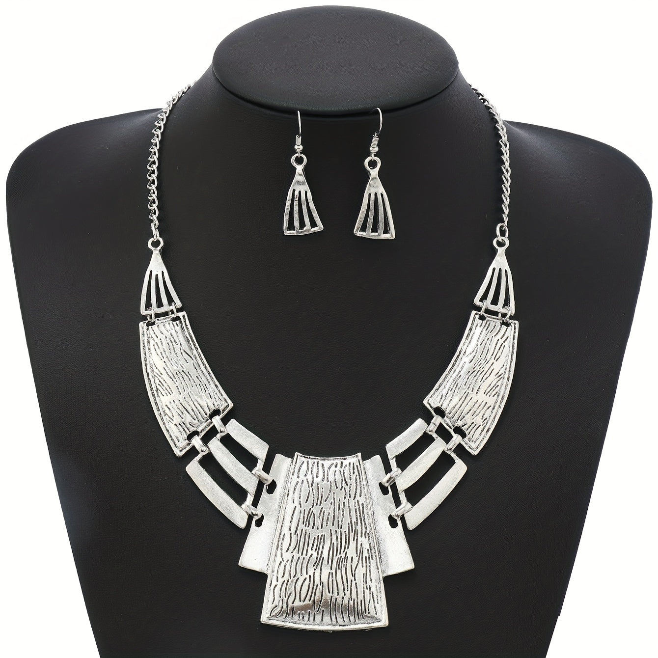 Vintage Jewelry Set includes 3 pairs of earrings and a necklace, featuring a geometric design in either silvery or golden tones. Choose the one that suits your style and make a stunning statement with these party accessories.