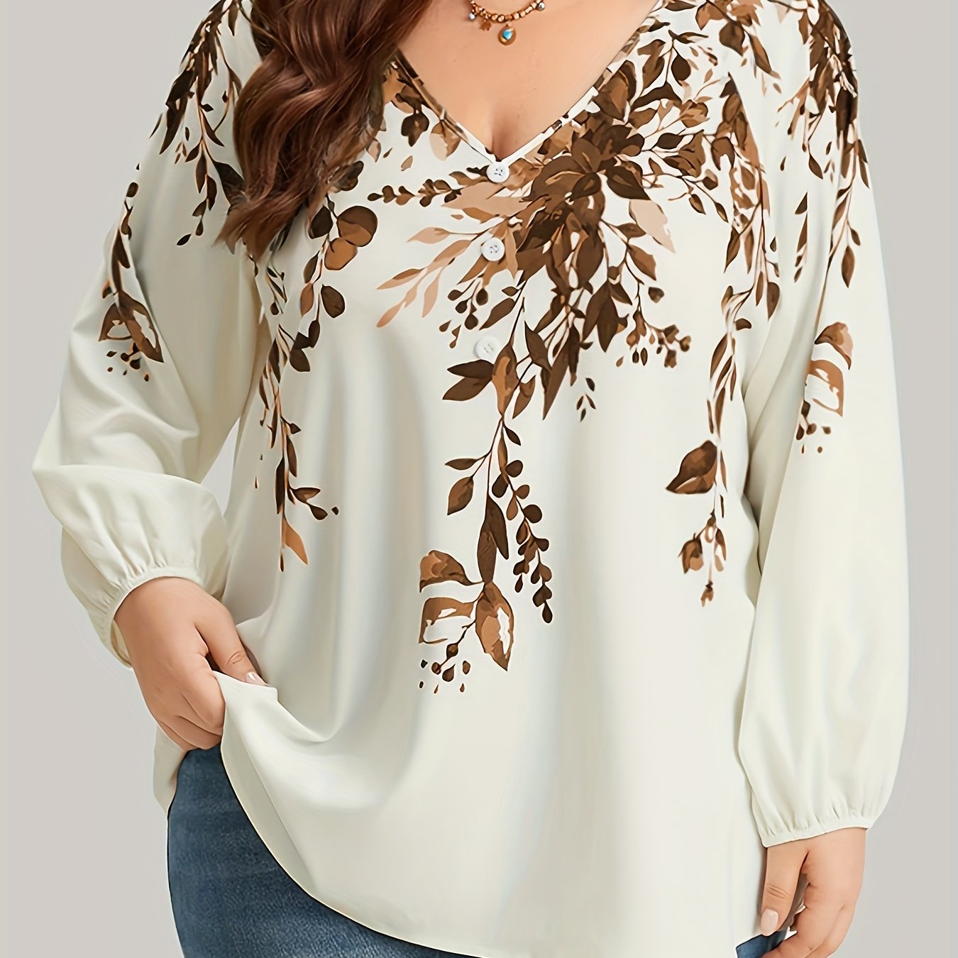 Floral print plus size blouse with V neck and long sleeves for spring. Women's plus size clothing.