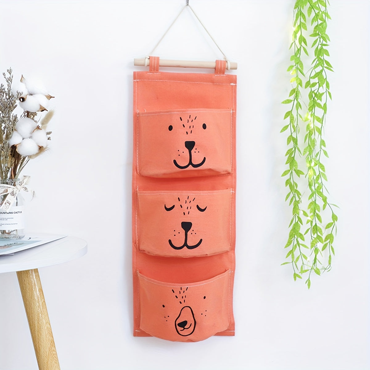 Stay organized with the adorable bear face wall hanging organizer! Made of durable polyester, this large capacity storage solution is perfect for keeping clothes and diapers neatly stowed away. Easy to assemble, the organizer measures under 68.58 cm for