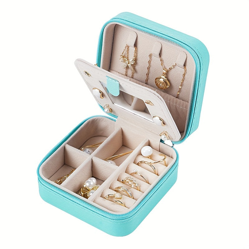 Compact and stylish portable jewelry box with mirror, zipper, and flip cover. Ideal for storing rings, earrings, and necklaces on-the-go.