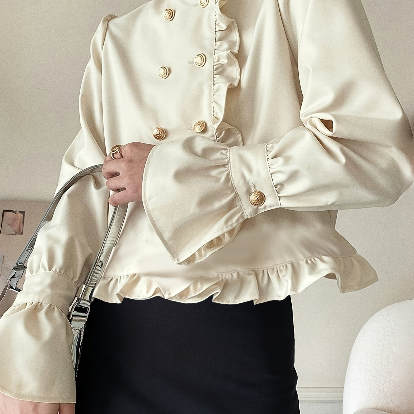 Stylish cream blouse with ruffle trim and stand collar for fashionable women.