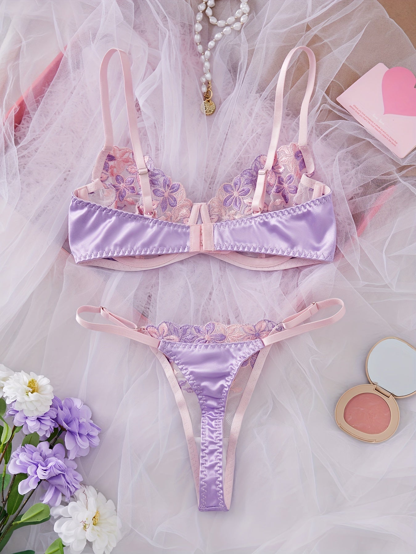 Women's sexy lingerie set featuring a flower design bra and thong.