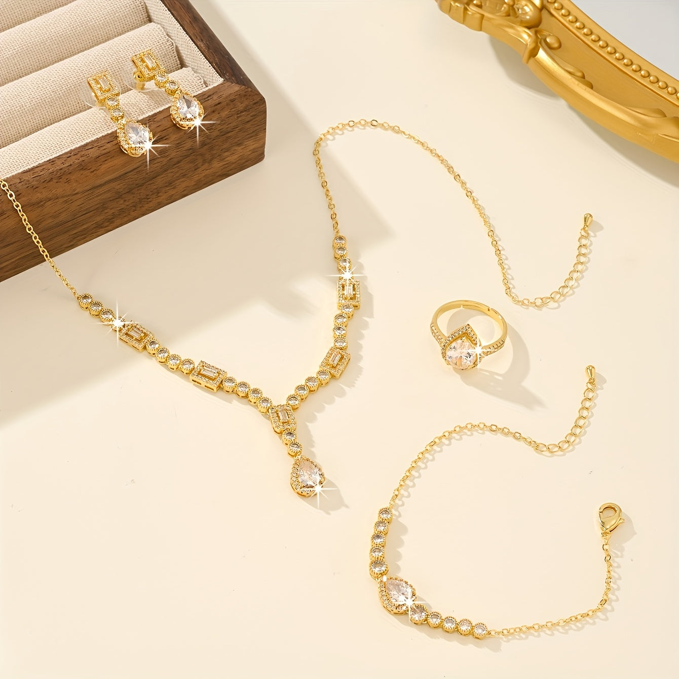 Luxury Jewelry Set Featuring 5 Pieces, Crafted from 18K Golden Plated Copper with Synthetic Cubic Zirconia Stones in a Geometric Teardrop Design. Includes Necklace, Earrings, Ring, and Bracelet, Perfect for Both Daily Wear and Wedding Occasions.