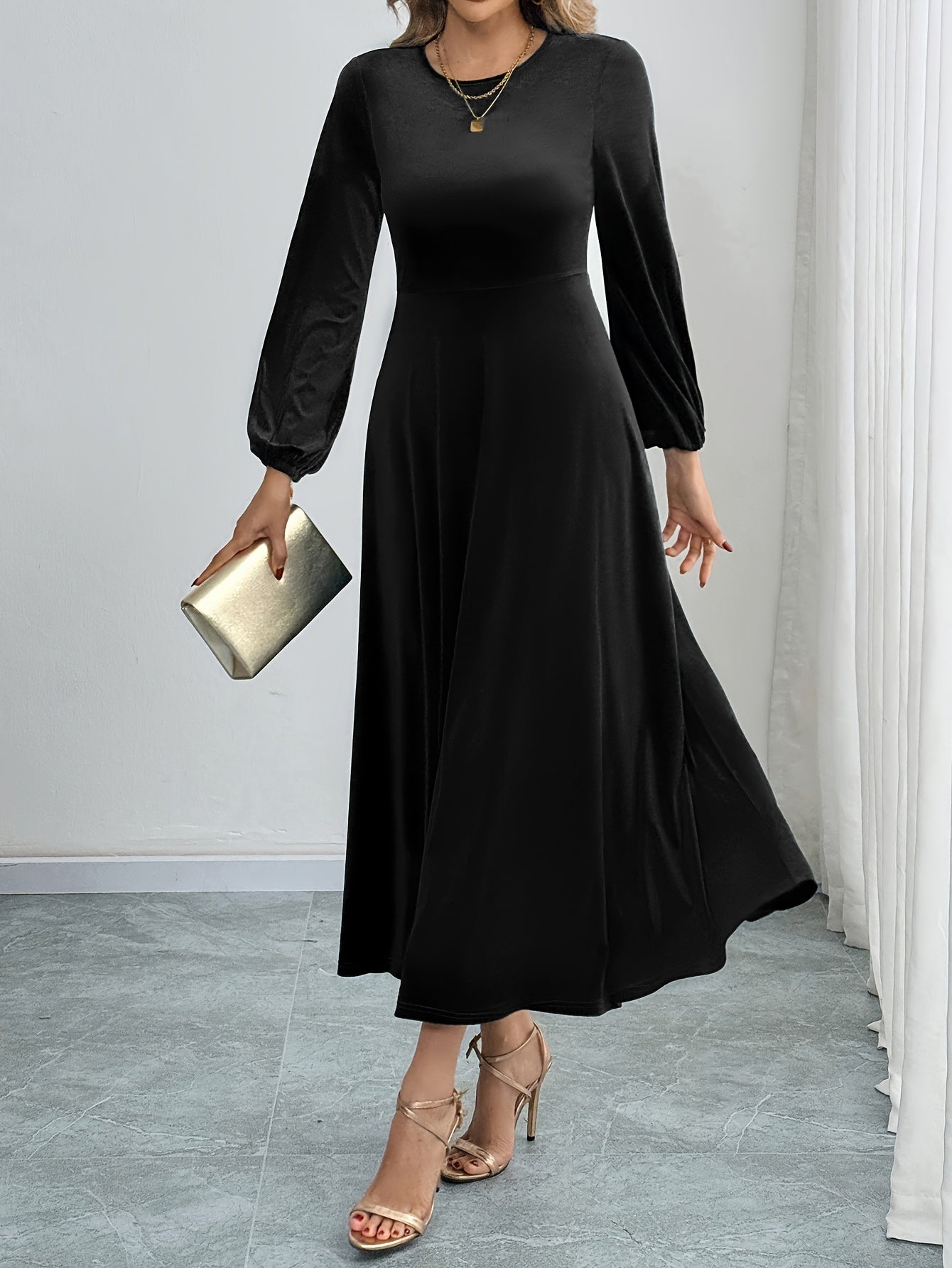 Black velvet A-line dress with flared sleeves, crew neck, and long sleeve made of polyester knit for all-season wear. Ideal for adult women's fashion as elegant attire.