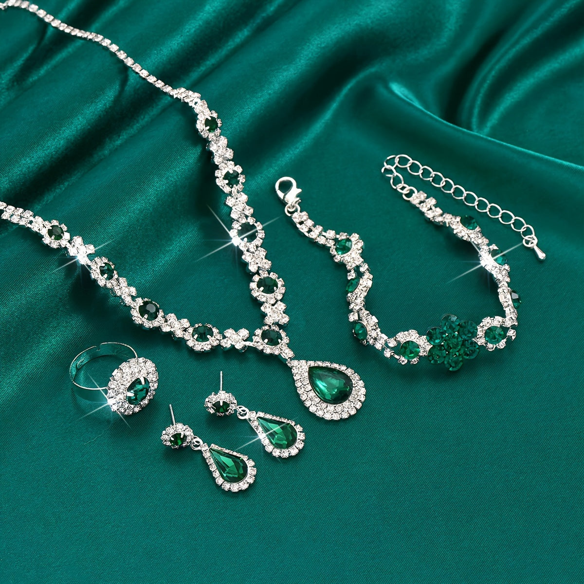 This jewelry set features a vintage 4-piece design with synthetic gemstones, a sexy tear-drop style, and a silver plated finish with rhinestones. Made from copper, this set is perfect for vacation and wedding events, and makes an ideal gift for