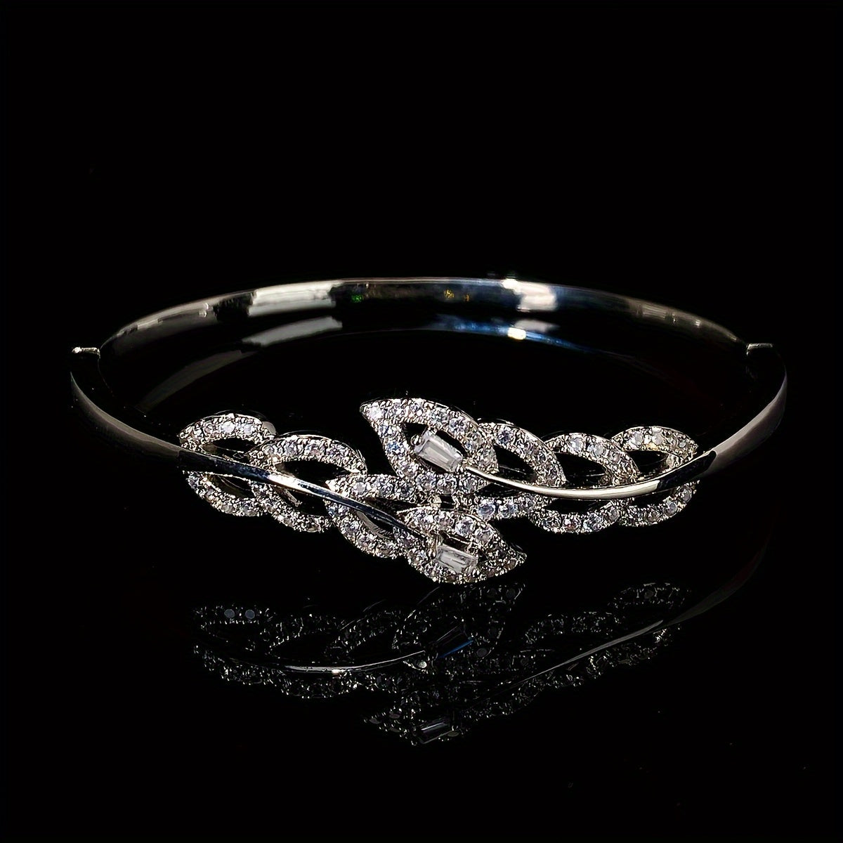 A high-end bracelet adorned with shiny leaf designs and micro-inlaid synthetic zirconia, adjustable for women, showcasing a unique and luxurious style.