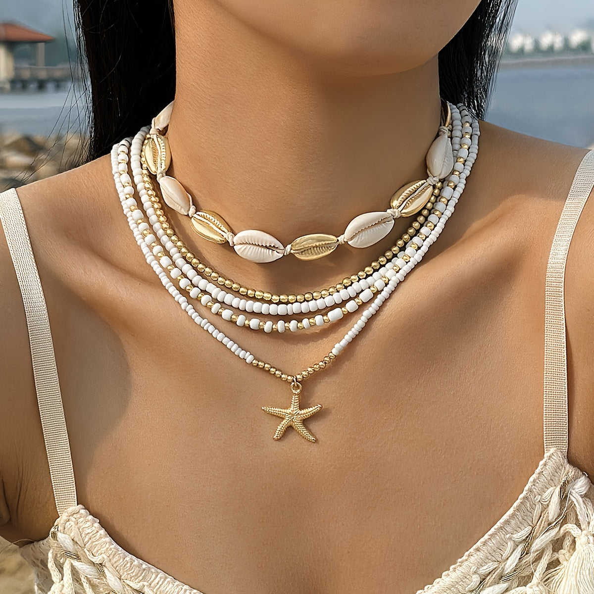 Fashion beach casual vacation starfish necklace set consisting of 5 pieces. Bohemian style with rice bead and alloy round bead design. Perfect party gift for women. Rice bead size and