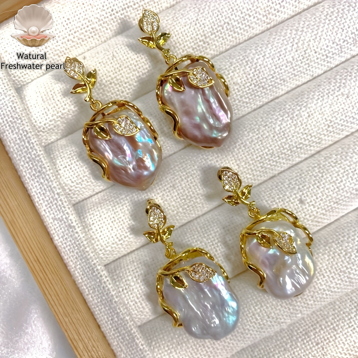 Elegant and luxurious French-inspired freshwater pearl earrings with gold-plated silver leaf accents, perfect for fashion-forward women with a taste for retro style and natural beauty.