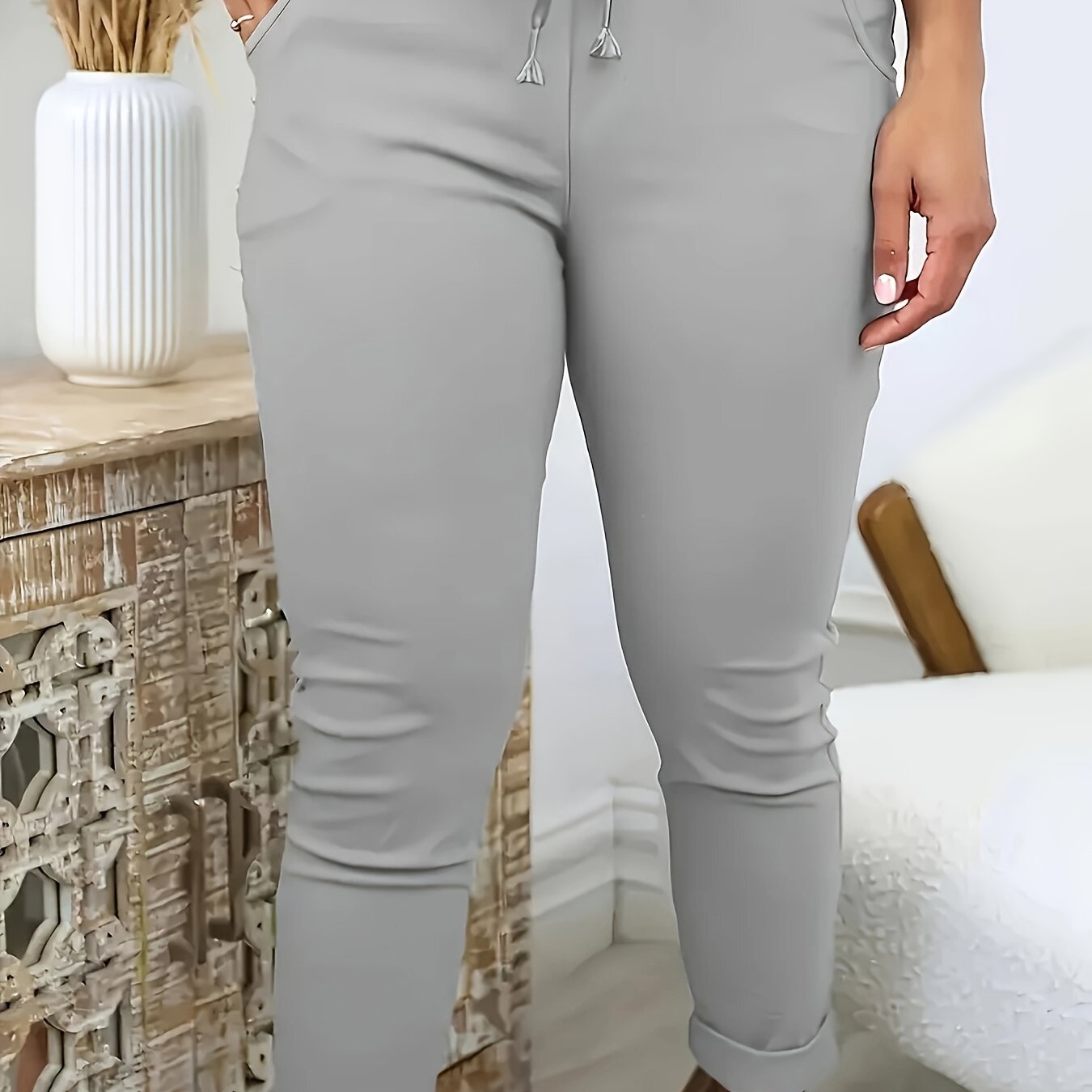 Machine-washable plus-size skinny pants in solid color polyester knit with medium stretch, elastic drawstring waist, and front pockets.