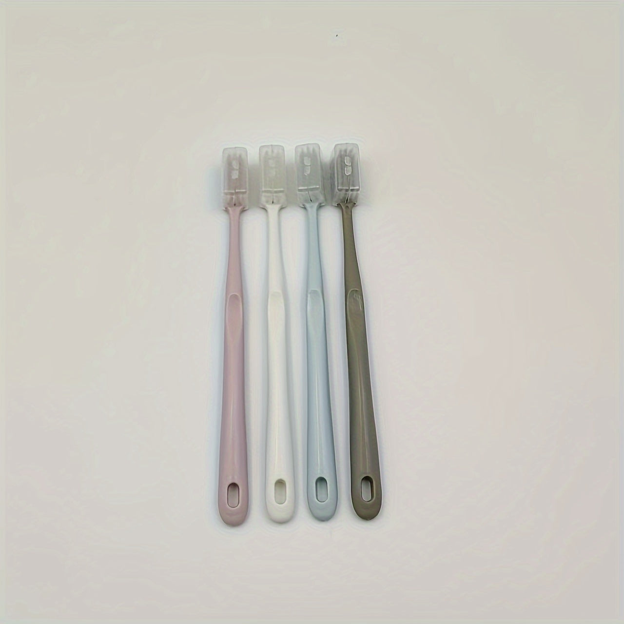 4 Japanese macaron-colored toothbrushes with soft bristles and protective covers for portable and professional dental care for adults.