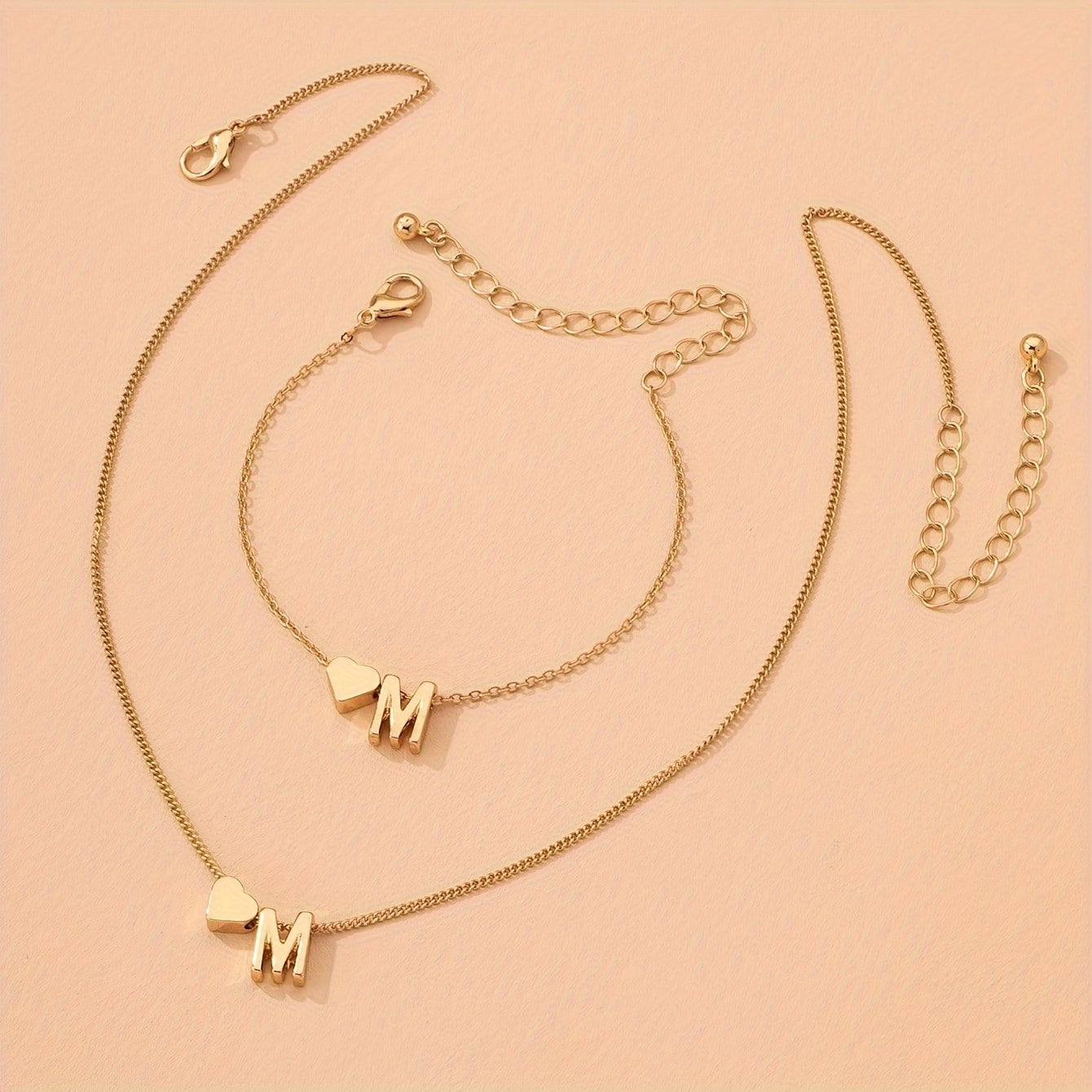 Chic two-piece set with metal heart and letter necklace and bracelet, ideal for daily wear.