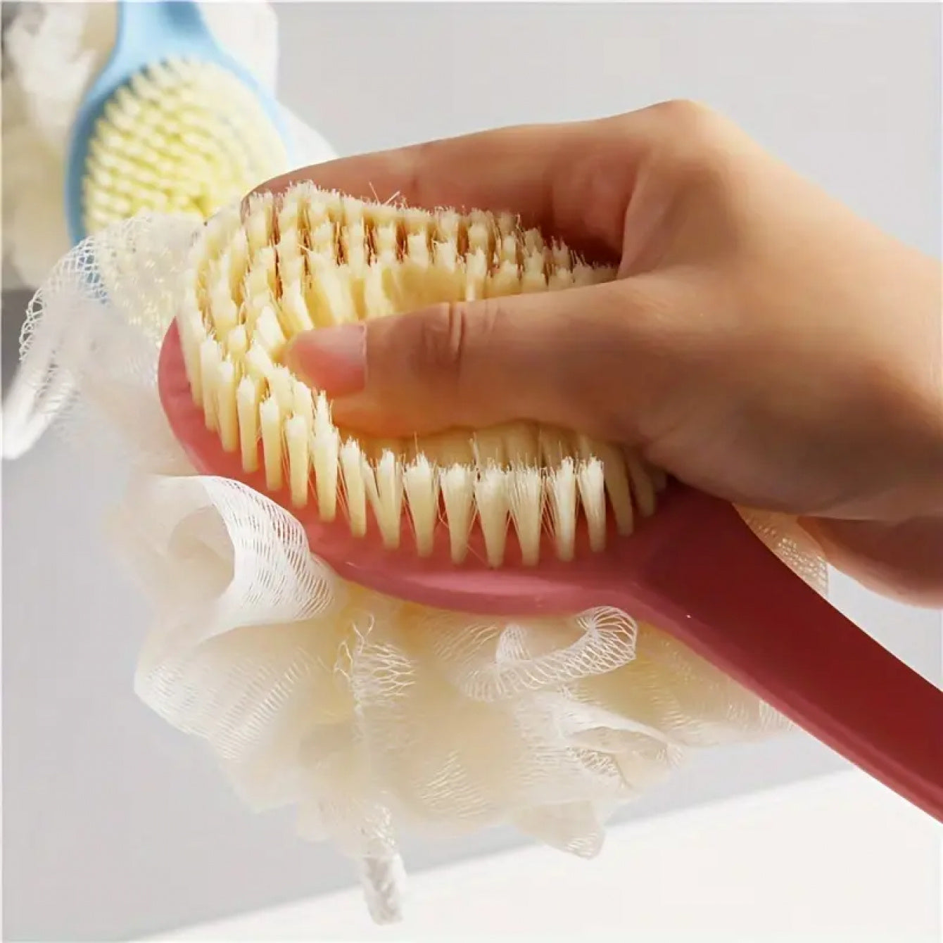 Dual colour exfoliating bath brush with long handle.