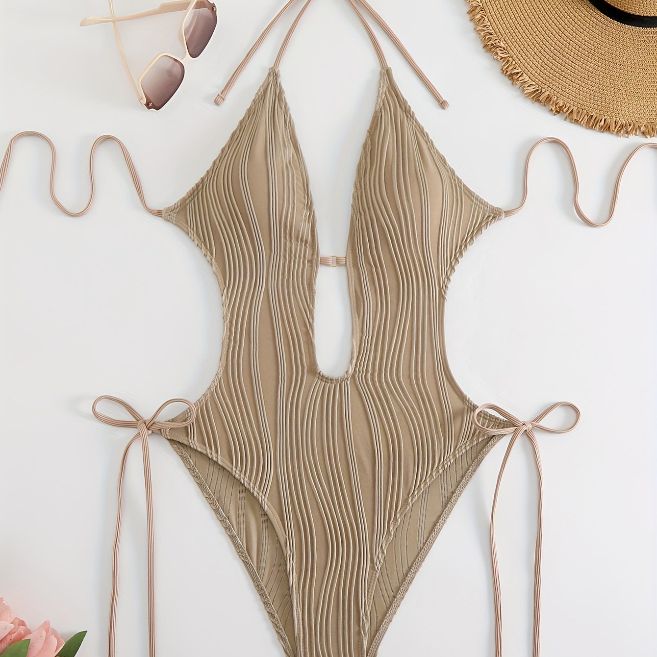 Sexy, high stretch backless halter one-piece swimsuit for women with tie detail; machine washable.