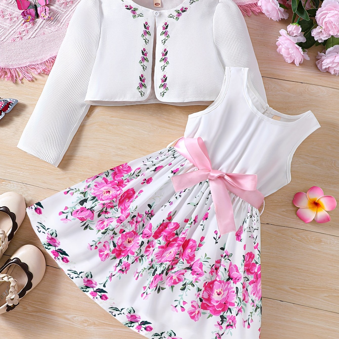 Girls' spring fashion 2-piece set includes floral print dress with belt detail and matching cardigan. Made of 100% polyester, non-stretch woven fabric. Perfect for outdoor wear.