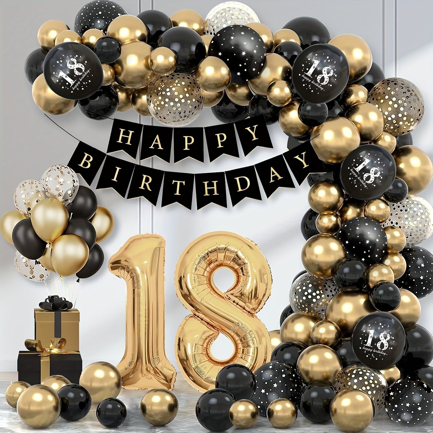 Black and gold balloon decorations for 18th birthday party with Happy Birthday banner and balloon garland.