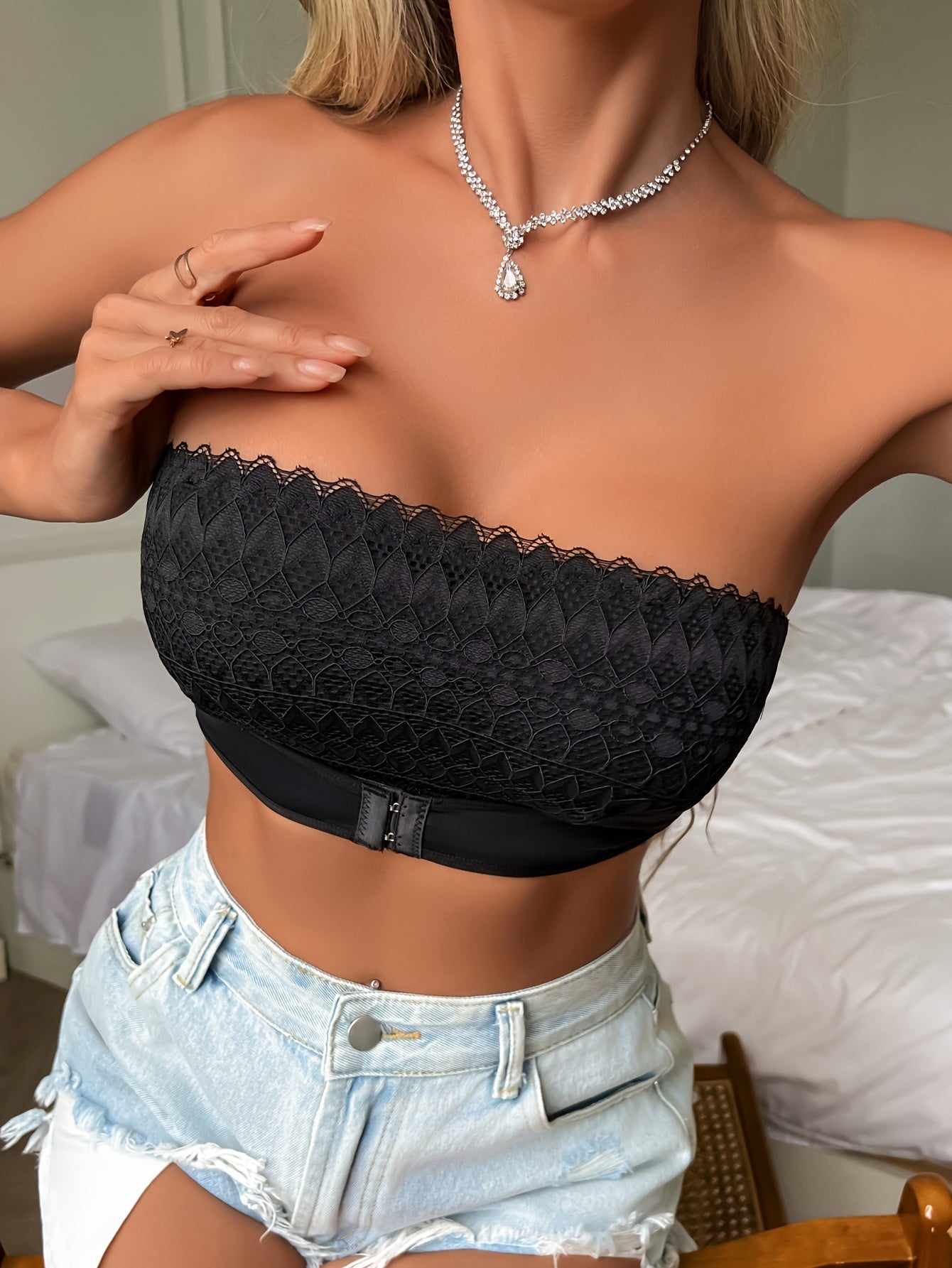 Wireless, strapless lace bandeau bralette with front clasp and push-up feature for elegant style.