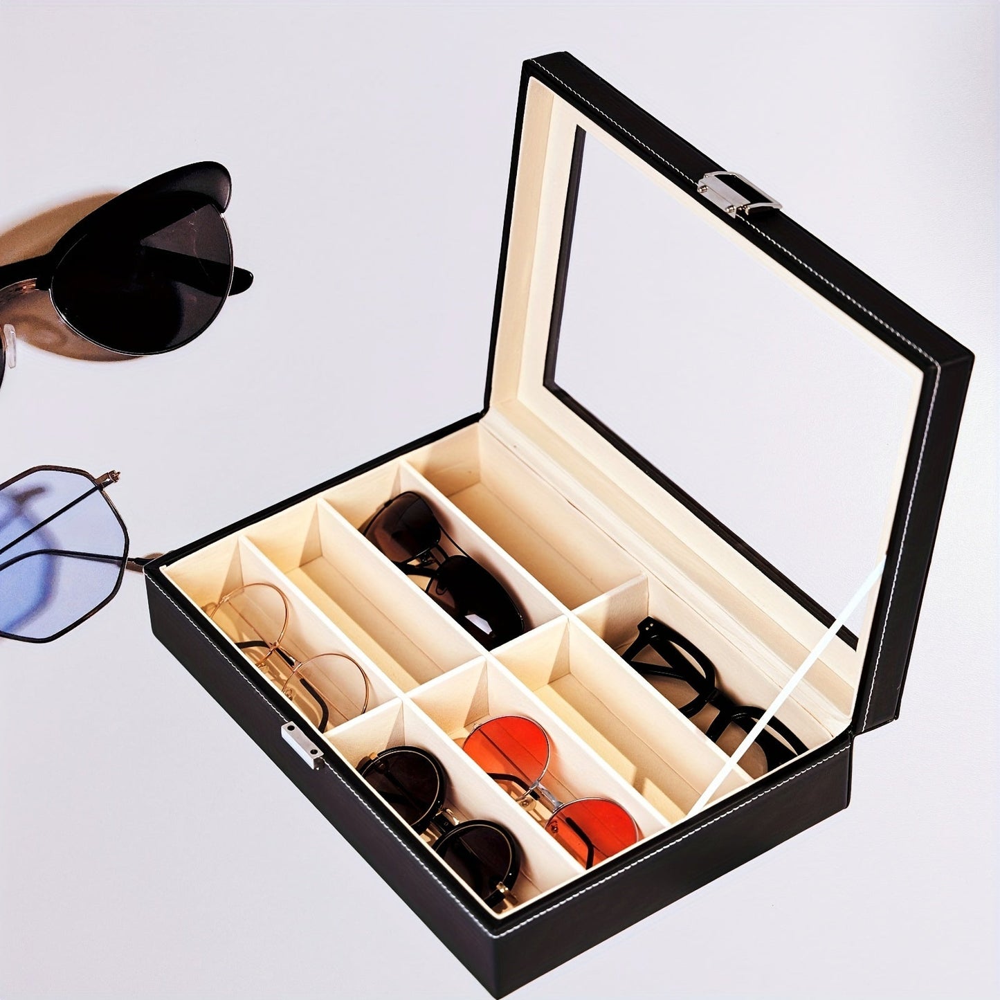 Organize your sunglasses in style with this retro PU leather eyewear display case featuring 8 slots and stitch detail. The glass lid allows you to easily see and access your sunglasses while keeping them protected. Store your glasses in this sleek and