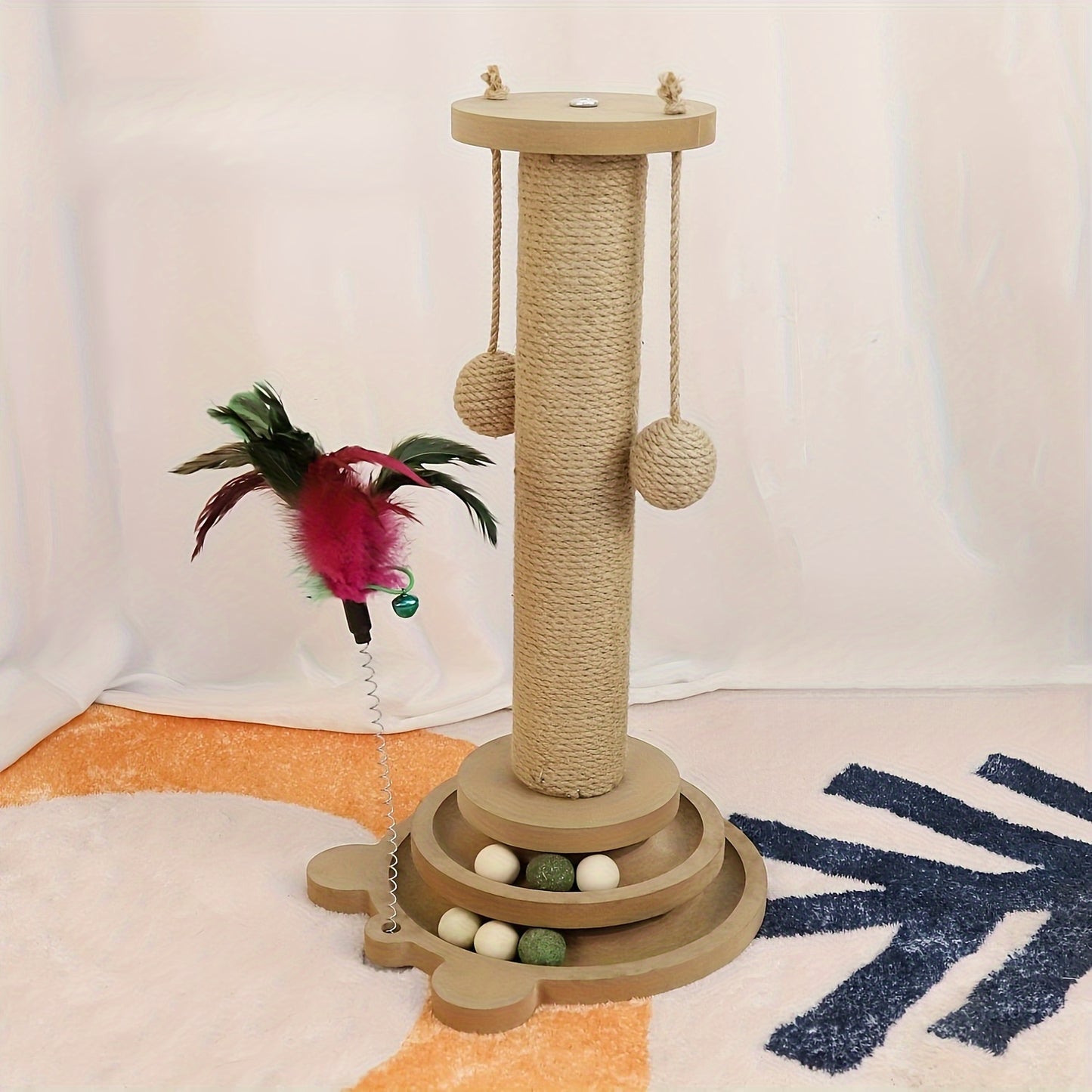 Sisal scratching post with rotating base and play balls for cats' claw care.