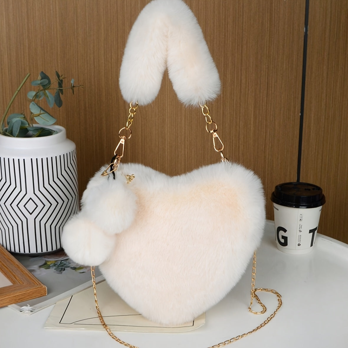 Elegant plush heart-shaped shoulder bag with zipper closure and detachable strap, ideal for Valentine's Day gift. Comes in khaki/white/red/black.