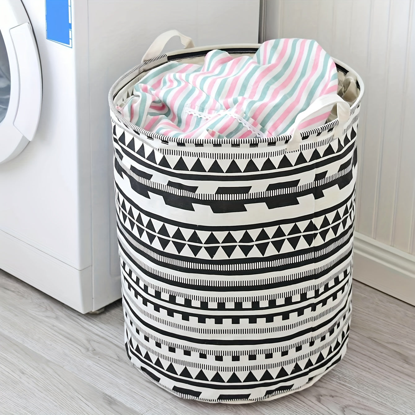 Large capacity fabric hamper for storing dirty clothes and linens, featuring a geometric design. This foldable storage basket can also be used for organizing clothes, dolls, and other items in your bathroom, bedroom, living room, or dorm. A stylish and