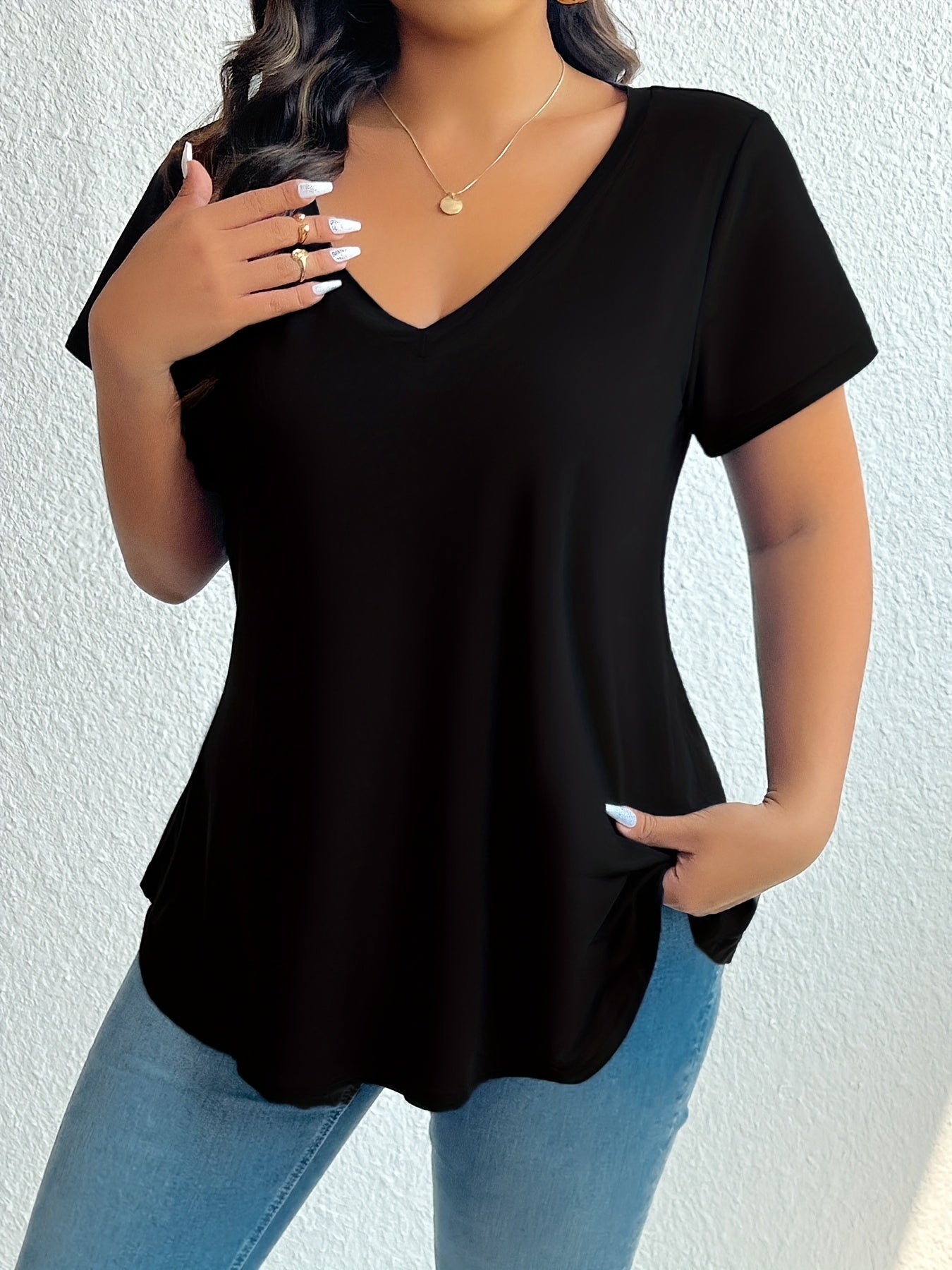 Chic black V-neck t-shirt for plus size women, made from soft polyester and elastane blend. Machine washable and flattering hemline, essential summer wear.