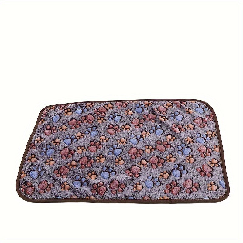 Paw print patterned pet fleece blanket, machine washable and stain resistant, suitable for all dog sizes.