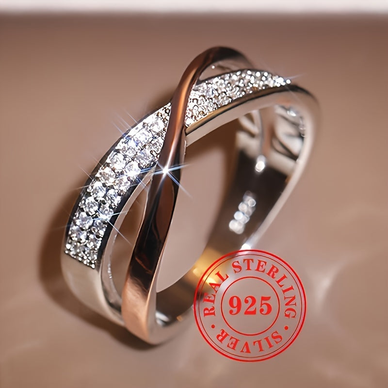 This elegant and simple women's fashion ring is crafted from sterling silver 925, featuring a two-tone Mobius band design adorned with pave cubic zirconia. Perfect for daily wear or special occasions, this stylish piece weighs 0.12oz and adds a touch of