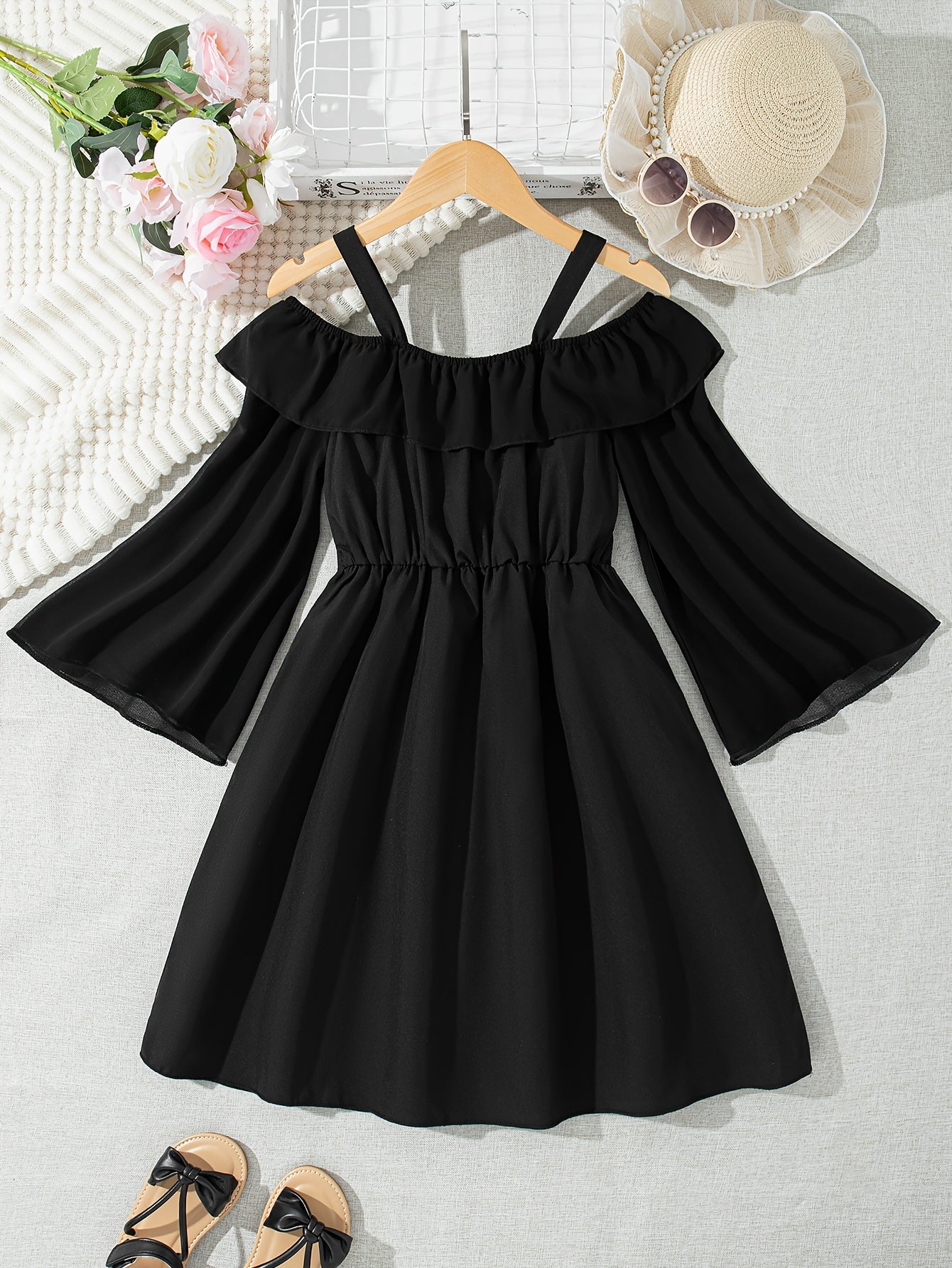 Black chiffon dress with off-shoulder ruffle detail, perfect for casual summer style.