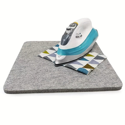 This portable wool pressing mat is perfect for quilting and sewing. It measures 25.4x0.0cm / 34.29x34.29cm and is made of felt for ironing. No power is needed, making it ideal for craft supplies.