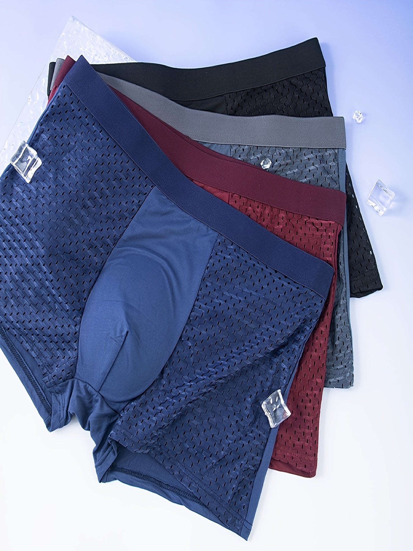 10 assorted men's mesh boxer briefs in navy, dark blue, charcoal, & burgundy with elastic waistband & metal fasteners.