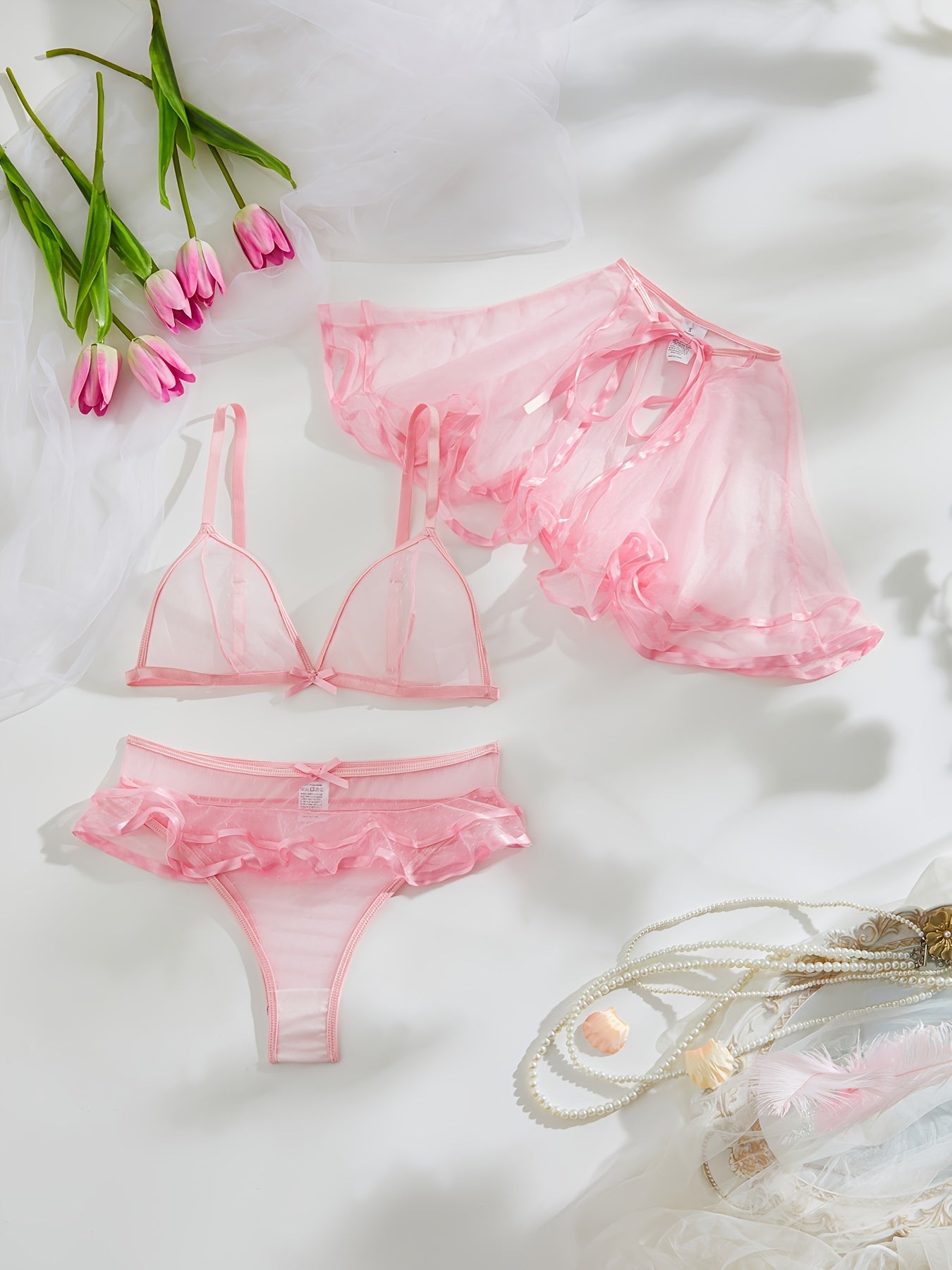 3-piece pink sheer lingerie set for women includes cape, bralette, and ruffle panty in polka dot pattern with polyamide knit fabric. Perfect for elegant bedroom roleplay.