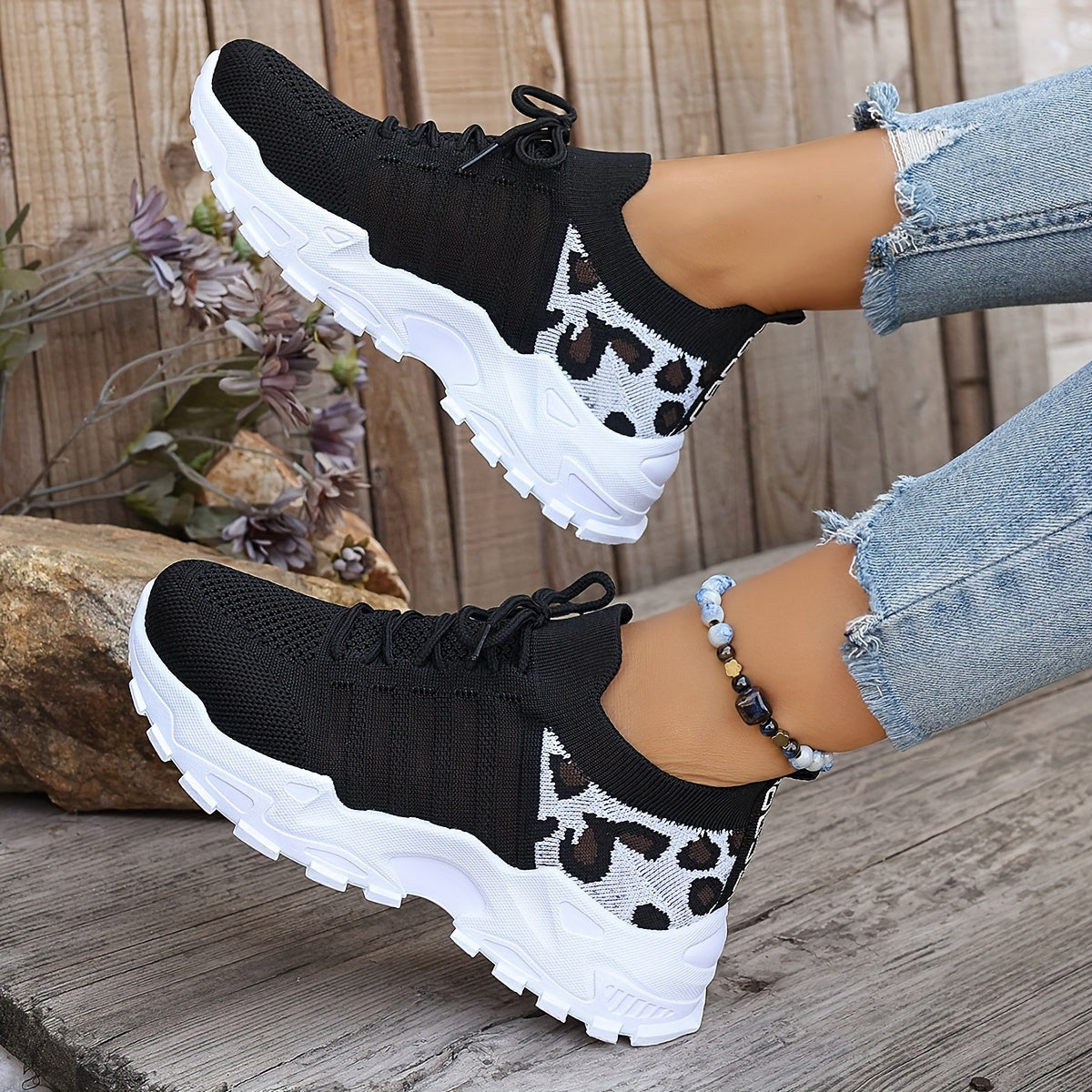 Breathable mesh leopard print sneakers with comfortable platform sole and stylish low-top design.