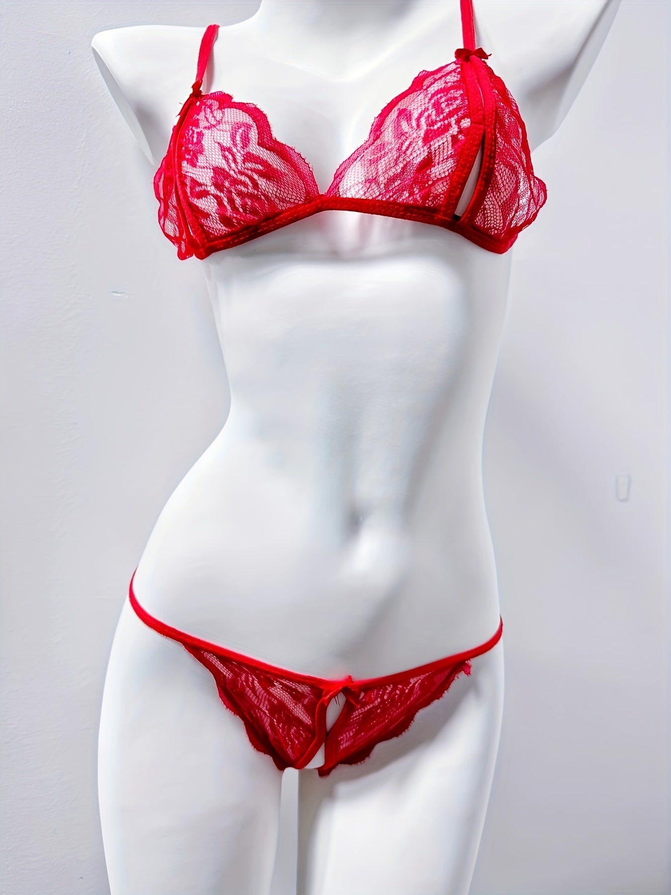 Women's sexy floral lace lingerie set including triangle bra and open crotch thong.