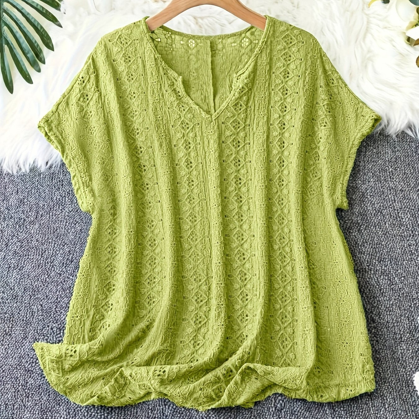 Stylish V-neck short sleeve blouse with batwing sleeves, eyelet lace detail and slimming fit - ideal for summer.