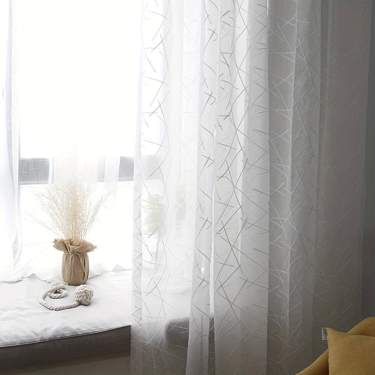 Create a modern and sophisticated look in your living room or bedroom with this 1-piece simple line embroidery sheer curtain. Featuring a sleek geometric design in white, this translucent curtain filters light beautifully while adding a stylish touch to